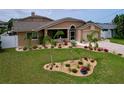 Attractive home with colorful landscaping, stone accents and charming curb appeal at 386 Westwinds Dr, Palm Harbor, FL 34683
