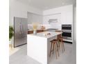 Modern kitchen boasts stainless steel appliances, a center island, and a sleek, minimalist design at 400 Central Ave # 808, St Petersburg, FL 33701