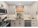 Contemporary kitchen featuring sleek cabinets, stainless steel appliances, and marble countertops at 4214 Harbor House Dr, Tampa, FL 33615