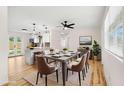 Bright dining room with modern decor, stylish lighting, and an open view of the kitchen at 4414 W Oklahoma Ave, Tampa, FL 33616