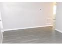 Neat living room featuring a window, wood-look flooring and baseboard at 4417 Kohler St, New Port Richey, FL 34652
