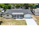An aerial view of a one-story home with a driveway and well maintained roof at 4638 Durney St, New Port Richey, FL 34652