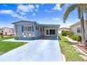 Single-story home with a covered carport and well-maintained driveway at 4904 Winged Foot Ave, Sarasota, FL 34234