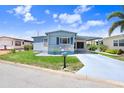 Inviting single-story home featuring a covered carport and a vibrant blue exterior at 4904 Winged Foot Ave, Sarasota, FL 34234