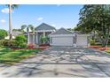 Beautiful two-story home with a three car garage and a luscious green front lawn at 4959 Felecity Way, Palm Harbor, FL 34685