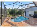 Private screened-in pool and spa area with an outdoor patio, perfect for relaxation and entertaining at 4959 Felecity Way, Palm Harbor, FL 34685