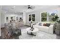 Bright living room with an open layout, white walls, and hardwood flooring, seamlessly connected to the kitchen at 5701 N 20Th St, Tampa, FL 33610