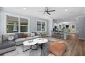 Open-concept living room featuring a modern kitchen, comfortable seating, and abundant natural light at 5703 N 20Th St, Tampa, FL 33610