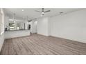 Spacious, open-plan living room featuring light hardwood flooring and contemporary design at 5705 N 20Th St, Tampa, FL 33610