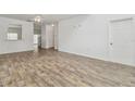 Open living room with light wood floors, white walls and ceiling fan at 6234 Ashbury Palms Dr, Tampa, FL 33647