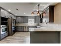 Modern kitchen with gray cabinets, stainless appliances, and a spacious countertop at 8330 Lafitte Dr, Hudson, FL 34667