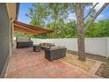 Outdoor patio with cozy seating area, hot tub and retractable awning for shade at 8518 Tidal Breeze Dr, Riverview, FL 33569
