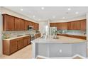 Spacious kitchen featuring a large island with granite countertops and ample cabinet space at 11423 Brighton Knoll Loop, Riverview, FL 33579