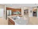 Beautiful kitchen with stainless steel appliances, granite countertops, and ample cabinet space at 11423 Brighton Knoll Loop, Riverview, FL 33579