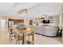 Open-concept living space with a kitchen island, dining area, and comfortable seating at 11423 Brighton Knoll Loop, Riverview, FL 33579