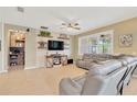 Cozy living room features a modern entertainment center, tile flooring, and comfortable leather furniture at 11423 Brighton Knoll Loop, Riverview, FL 33579