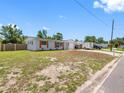 Wide angle of a single-story home with updated shutters, garage, and car port at 1213 W Camellia Dr, Brandon, FL 33510