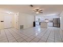 A bright, open-concept living area and kitchen features tile flooring and stainless steel appliances at 201 Westwood N Ter, St Petersburg, FL 33710
