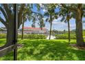 Patio view capturing lush greenery and tranquil waterfront scenery, creating a private and relaxing outdoor space at 2363 Hanover Dr, Dunedin, FL 34698