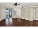 View of an open-concept living room with hardwood floors and sliding door access at 23917 Pow Wow Dr, Lutz, FL 33559