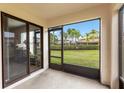 View from screened in porch featuring a serene outdoor space and sliding glass doors to the yard at 2628 Oleander Lakes Dr, Brandon, FL 33511