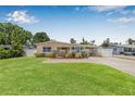 Charming home boasts a well-manicured lawn and a welcoming brick walkway, leading to a covered carport at 2861 Pinellas Point S Dr, St Petersburg, FL 33712