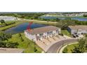 Aerial view of the rear of townhomes located near a retention pond at 308 Mangrove Shade Cir, Apollo Beach, FL 33572