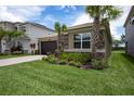 Beautiful home with a paver driveway, lush landscaping, and mature palm trees, offering a welcoming curb appeal at 3318 Woodland Brook Way, Wesley Chapel, FL 33543