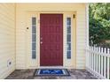 Inviting entryway showcasing a red front door, sidelights, and patterned tile on the porch at 346 Gray Oak Dr, Tarpon Springs, FL 34689