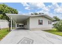 Inviting single-story home with a covered carport, well-maintained lawn, and beautiful landscaping at 36731 Tara Ave, Zephyrhills, FL 33542
