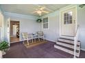 Cozy screened patio with seating and fan, perfect for relaxing and entertaining at 36731 Tara Ave, Zephyrhills, FL 33542