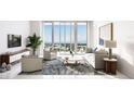 Stylish living room with floor-to-ceiling windows offering panoramic views and sophisticated decor at 400 Central Ave # 2705, St Petersburg, FL 33701