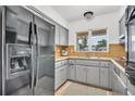 Bright and functional kitchen with ample gray cabinetry, modern appliances, and a convenient layout at 410 N Corona Ave, Clearwater, FL 33765