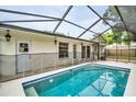 Inviting backyard pool featuring a screened enclosure, perfect for outdoor relaxation and entertainment at 410 N Corona Ave, Clearwater, FL 33765