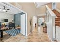 Bright foyer with tall ceilings opens to office space and stairway at 4151 Little Gap Loop, Ellenton, FL 34222