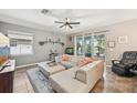 Comfortable living room featuring a large sectional and sliding glass doors at 4151 Little Gap Loop, Ellenton, FL 34222