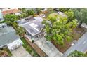 Aerial view of property with a pool, mature trees, and a convenient carport at 4419 W El Prado Blvd, Tampa, FL 33629