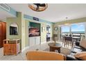 Living room features a comfortable seating area with view to outdoor patio overlooking the beach at 4510 Gulf Blvd # 604, St Pete Beach, FL 33706
