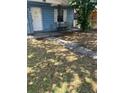 Front yard with a walkway leading to the entrance of a modest one-story home at 5211 E 17Th Ave, Tampa, FL 33619