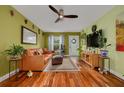 Comfortable living room features hardwood floors and large front window at 5700 Pacific N St, St Petersburg, FL 33703