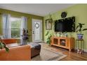 Inviting living room with hardwood floors, decorative wreath, and natural light at 5700 Pacific N St, St Petersburg, FL 33703