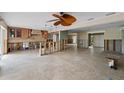 Expansive living area featuring tile flooring, natural light, and unfinished elements for a personalized design at 648 Geneva Pl, Tampa, FL 33606