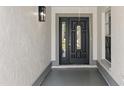 A welcoming entryway with a stylish front door, side panel window, and neutral color palette at 6509 W Longboat Blvd, Tampa, FL 33615