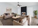 Bright living room featuring modern decor, a cozy fireplace, plush seating, and neutral walls at 6509 W Longboat Blvd, Tampa, FL 33615