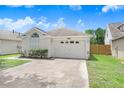 Charming one-story home featuring a well-maintained lawn and attached two-car garage at 6801 Summer Cove Dr, Riverview, FL 33578
