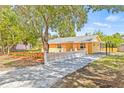 Beautifully renovated home with a new driveway and lush landscaping, offering great curb appeal at 6807 River Rd, Tampa, FL 33615