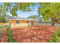 Beautiful single-story home showcases a lush front yard with colorful landscaping and a well-maintained lawn at 6807 River Rd, Tampa, FL 33615