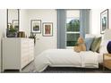 Charming bedroom with a dresser and a view of trees outside the window at 7758 Painted Sky Pl, Land O Lakes, FL 34637