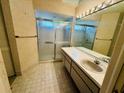 Bathroom with a shower stall, mirror, and cabinets at 8635 Braxton Dr, Hudson, FL 34667