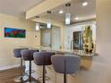 Charming breakfast bar with pendant lighting and seating, offering a cozy spot for casual dining at 100 Bluff View Dr # 115C, Belleair Bluffs, FL 33770